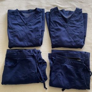 Two sets of navy Grey’s Anatomy scrubs